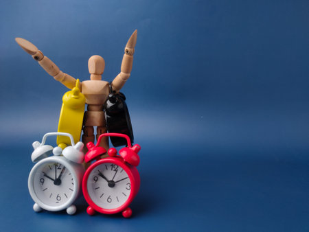 Wooden mannequin artist figure surrounded by several small, colorful retro-style twin bell alarm...