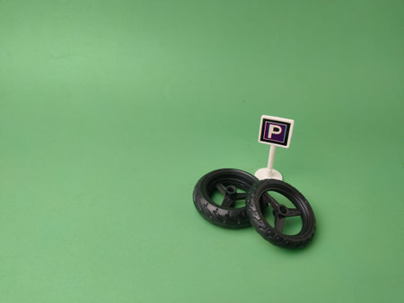 Parking sign labeled with a P along with miniature wheels.
