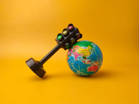 This image features a toy traffic light alongside a small globe.