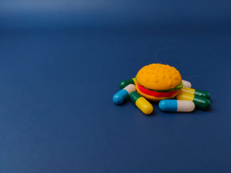 Surrounding the burger are several large, colorful capsules in various combinations.の写真素材