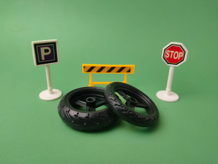 This image features a collection of small plastic toy accessories, including tires and traffic...