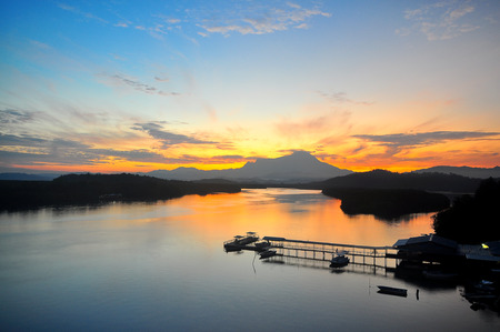 View of Mount Kinabalu in the far horizon seen from the Mengkabong Bridge Sabah Borneo Malaysia. during sunrise.の写真素材