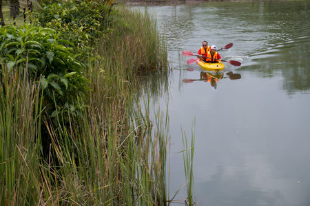 Kuala Lumpur, Malaysia - October 31, 2015 â Two men on kayak. Friends paddling in kayak in a river on a sunny day.のeditorial素材