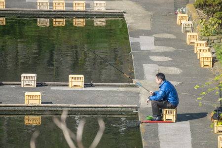 Tokyo, Japan - Nov 5, 2016. Fishing is activity of trying to catch fish. A man fishing by himself. Loneliness conceptのeditorial素材