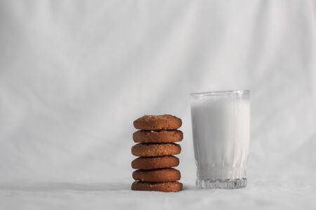 cookies and glass of milk on white backgroundの写真素材