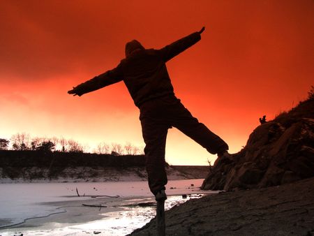 making a balance by the frozen lakeの写真素材