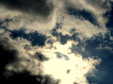 clouds hiding the sun in the skyの写真素材
