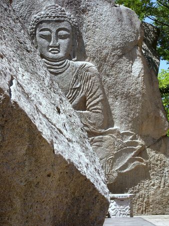 giant buddha carved on a rock in south koreaの写真素材