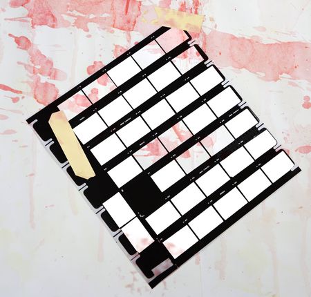 grungy printed contact sheet, with paint splatters,mounted with adhesive tape, blank picture franes, free copy space,grungy backgroundの写真素材