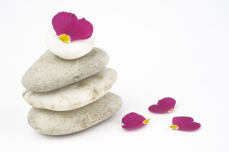 wellness and spa: flowers,pebbles stack, zen still life, isolated on white backgroundの写真素材