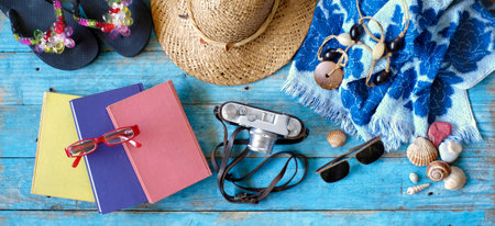 vacation and summer holidays, flat lay with books, camera, flip flops, seashells, sunglasses, beach towel, straw hatの写真素材
