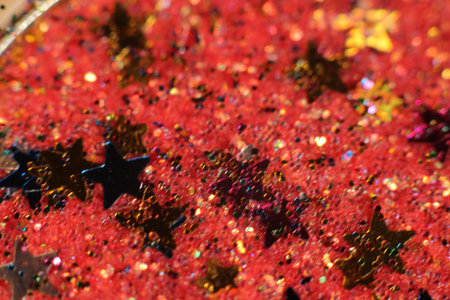 background of abstract glitter lights. gold, blue red, pink,and black. de focused