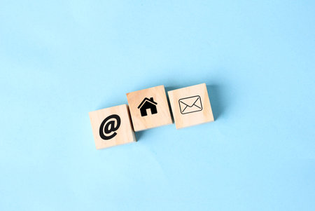 Wooden block cube symbol telephone, email, address and mobile phone. Website page contact us or...