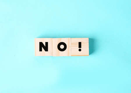 Wooden cubes with text no on a green background. Negative answer concept. No risk, no violence or no discrimination conceptの写真素材
