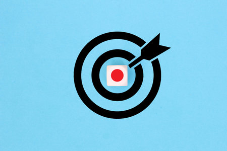Target with a wooden block as the bulls eye on Blue background. Concept of focusing on a target.