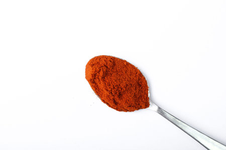 Pile of red paprika powder isolated on white background and texture