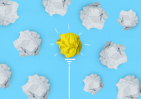 Creative idea, Inspiration, New idea, solution and Innovation concept with Crumpled yellow paper light bulb on blue backgroundの写真素材
