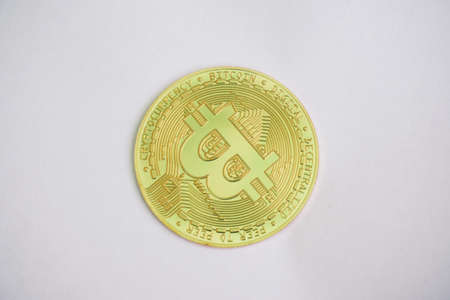 Close up golden coin with bitcoin symbol isolated on white backgroundの写真素材