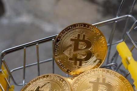 Close up golden coin with bitcoin symbol isolated on white backgroundの写真素材