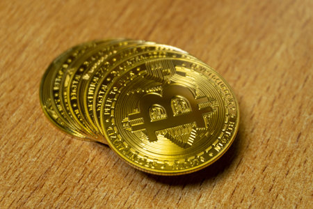 Close up golden coin with bitcoin symbol isolated on white backgroundの写真素材
