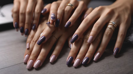 Female hands with purple nail design. Female hands with purple nail polish.の素材