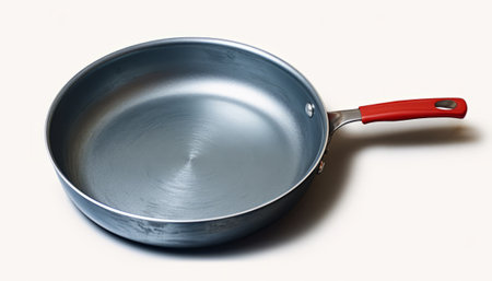 Frying pan with red handle isolated on white background. Top view.の素材