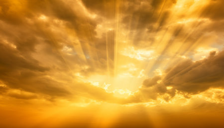 Sunset sky background with clouds and rays of light shining through themの素材