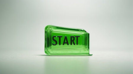 START - word on a green glass block on white background.の素材