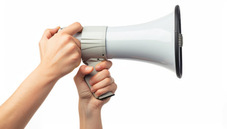Female hand holding a megaphone isolated on a white background.の素材
