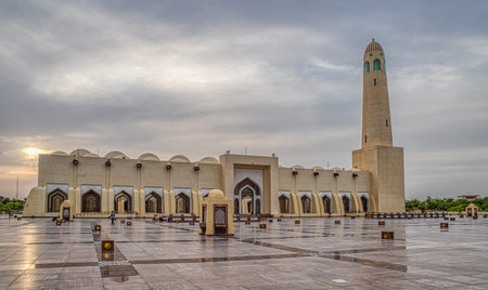 Imam Muhammad ibn Abd al-Wahhab Mosque (Qatar State Mosque) exterior view at sunset with clouds in...