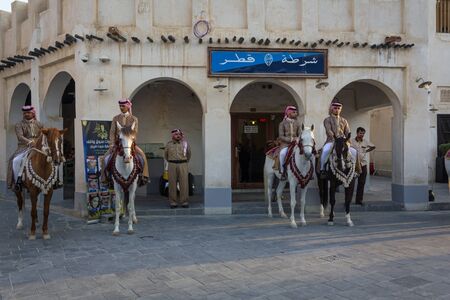Doha-Qatar,January 24,2013: Old police station in Souk Waqif Doha Qatar daylight view with traditional guards riding horses in front of itのeditorial素材