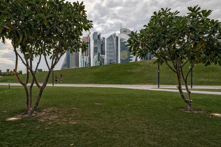 Doha, Qatar-November 18,2019: Doha, Qatar  Skyline daylight view from Sheraton park  with clouds in sky in backgroundのeditorial素材