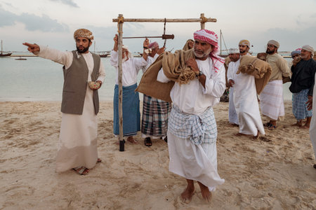 Doha,Qatar-December 11,2019: Traditional Arabic fishermen working  in Katara beach with dhows in the...
