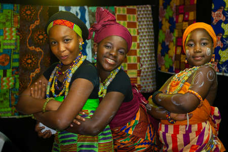Portrait of three African girls wearing Traditional tribe costume with blurred background shot taken during African festival in Katara cultural villageのeditorial素材