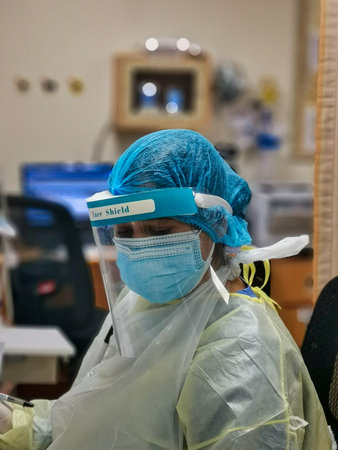 Female nurse wearing Personal protective equipment (PPE) in the hospital to fight against Corona virus disease (COVID-19)のeditorial素材