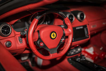 Ferrari F12 Berlinetta V12 GT sports car red dashboard interior shot showing the driving wheel in focusのeditorial素材