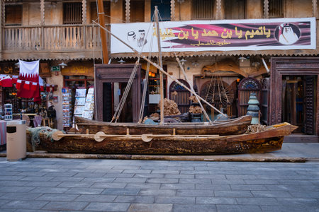 Souq Waqif Doha Qatar Main street at sunset showing Traditional Arabic wooden boat (Dhow) displayed...