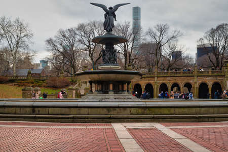 Bethesda Terrace and Fountain in Central Park New York  with the famous Angel of the Waters statue daylight view with people and clouds in skyのeditorial素材