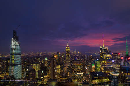 New York skyline from the top of  The rock observation deck in Rockefeller center at dusk with clouds in the skyのeditorial素材