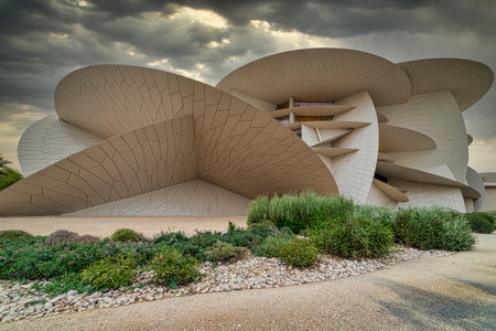 Museum of Qatar (Desert rose) panoramic external view at sunset with clouds in the sky in backgroundのeditorial素材