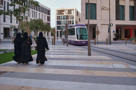 Msheireb Downtown Doha Daylight view showing the unique architecture of the buildings with Doha Metro and people walkingのeditorial素材