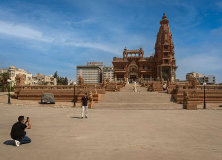 Baron Empain Palace (Le Palais Hindou) in Cairo, Egypt exterior daylight view showing the unique architecture of the palace with visitors walkingのeditorial素材