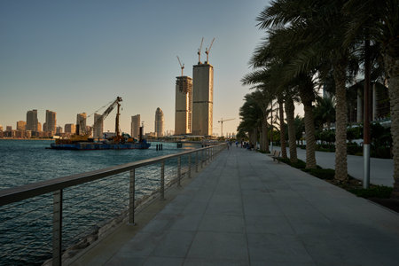 Lusail Corniche in Lusail city, Qatar at the marina daylight view showing people walking on the promenade  and skyline in backgroundのeditorial素材