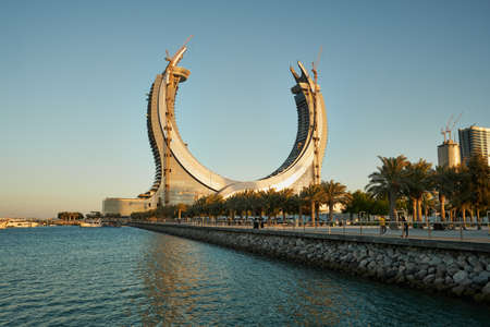 Lusail Corniche in Lusail city at the marina sunset shot showing people walking on the promenade with skyline in backgroundのeditorial素材