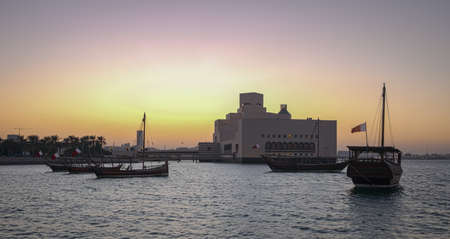 Museum of Islamic Art in Doha, Qatar exterior sunset shot showing  the unique architecture of the museum with dhows in Arabic gulf in foregroundのeditorial素材