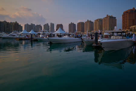 The pearl Marina in Porto Arabia , Doha Qatar daylight view with Yachts in foreground, buildings and clouds in the sky in backgroundのeditorial素材