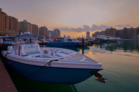 The pearl Marina in Porto Arabia , Doha, Qatar sunset view with Yachts in foreground, buildings and clouds in the sky in backgroundのeditorial素材