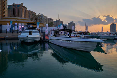 The pearl Marina in Porto Arabia , Doha, Qatar sunset view with Yachts in foreground, buildings and clouds in the sky in backgroundのeditorial素材