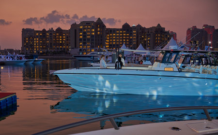 The pearl Marina in Porto Arabia in the Pearl, Doha Qatar night view with Yachts in foreground,...