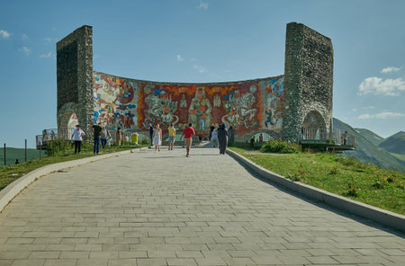 Russia Georgia Friendship Monument in Gudauri, Georgia external daylight view with visitors walking...